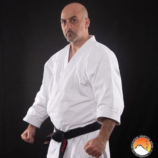 A man in white shirt and black belt
