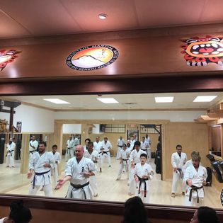 A group of people in white uniforms practicing karate.