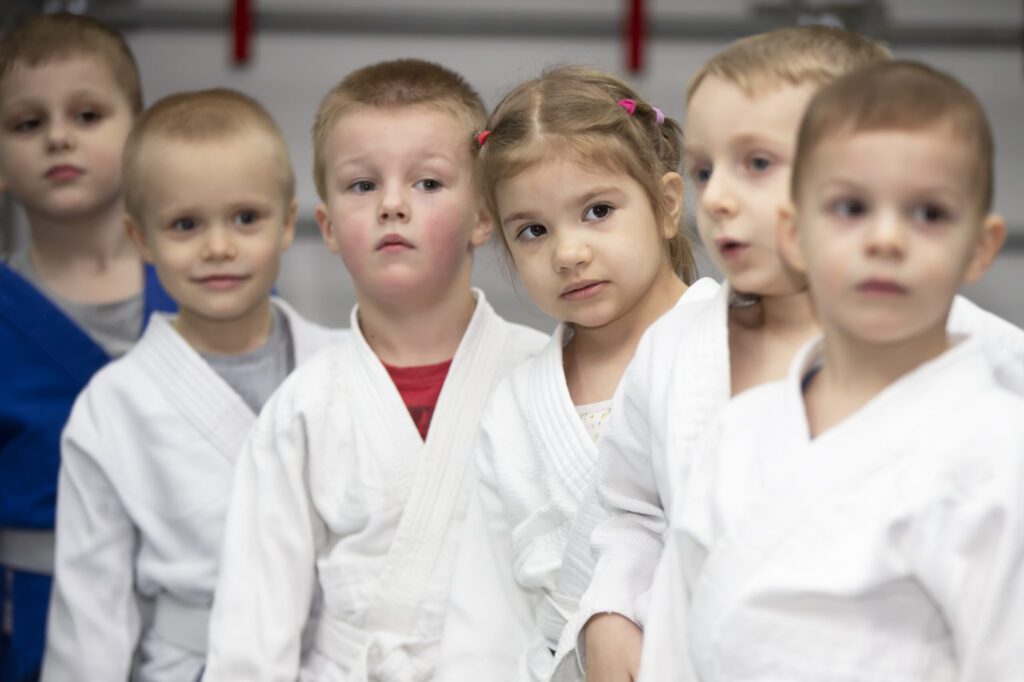 A group of young children in white uniforms.