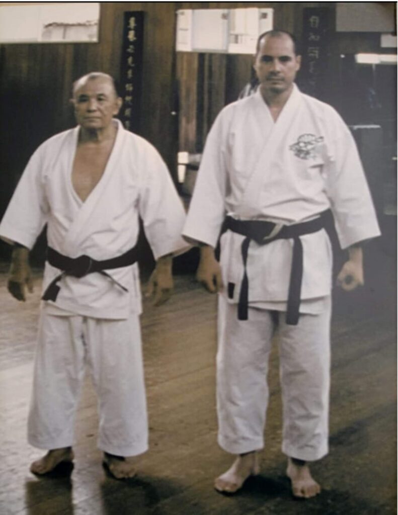 Two men in white and black uniforms standing next to each other.